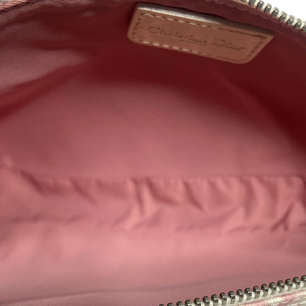 Christian Dior pink canvas monogram mini saddle pochette by John Galliano for Dior 2004 with white patent leather piping and strap, silver-tone hardware. Leather strap unclips at one end and can be looped to carry wristlet style. Top zipper closure with  pink textile interior. Duster and card included. Made in Spain 