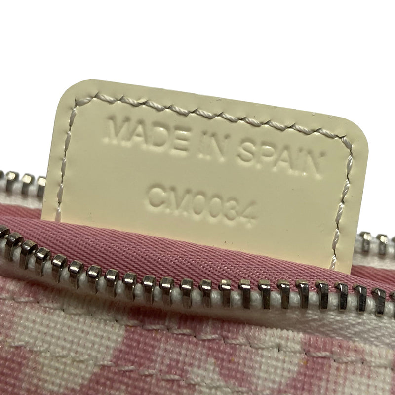 Christian Dior pink canvas monogram mini saddle pochette by John Galliano for Dior 2004 with white patent leather piping and strap, silver-tone hardware. Leather strap unclips at one end and can be looped to carry wristlet style. Top zipper closure with  pink textile interior. Duster and card included. Made in Spain 