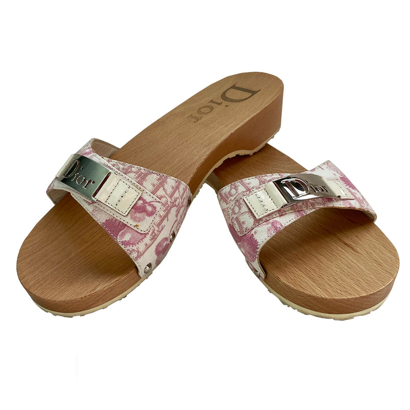 Christian Dior Girly Diorissimo floral slides Sandals, 2004 by John Galliano for Christian Dior. Pink and creme Diorissimo printed canvas upper features silver-tone cutout Dior logo plate,  ivory patent and silver-tone side studs. Dior logo stamped into wood sole with white rubber bottom DIOR logo stamped lower soles. 