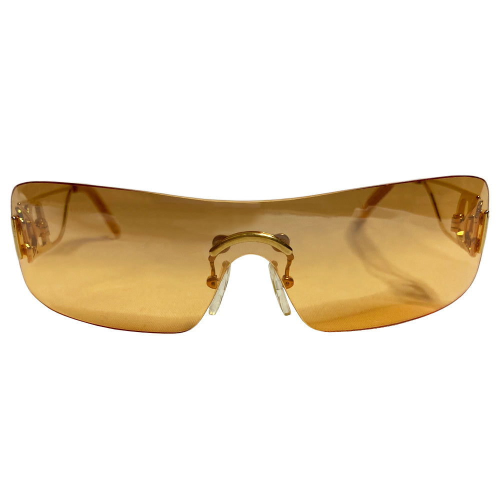 Christian Dior Miss Diorella sunglasses, rectangular slightly mirrored rimless shield lens with gold-tone metal split arms and logo D at temple, adjustable nose pieces 100% UV protection. Sunset orange with gold-tone metal frames Style: Missdiorella/N 34NSP 125 Case and card included. Made in Austria 