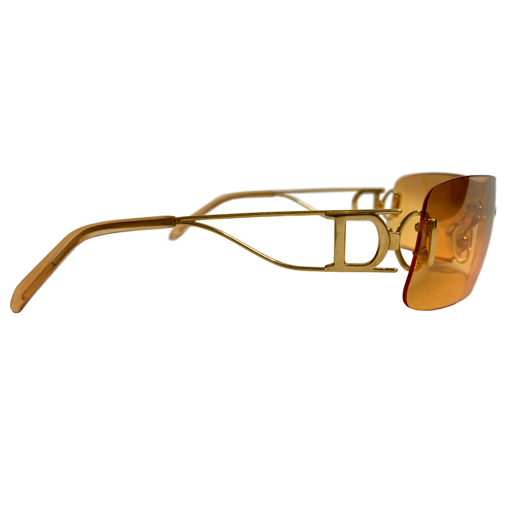 Christian Dior Miss Diorella sunglasses, rectangular slightly mirrored rimless shield lens with gold-tone metal split arms and logo D at temple, adjustable nose pieces 100% UV protection. Sunset orange with gold-tone metal frames Style: Missdiorella/N 34NSP 125 Case and card included. Made in Austria 