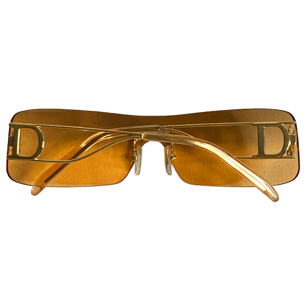 Christian Dior Miss Diorella sunglasses, rectangular slightly mirrored rimless shield lens with gold-tone metal split arms and logo D at temple, adjustable nose pieces 100% UV protection. Sunset orange with gold-tone metal frames Style: Missdiorella/N 34NSP 125 Case and card included. Made in Austria 