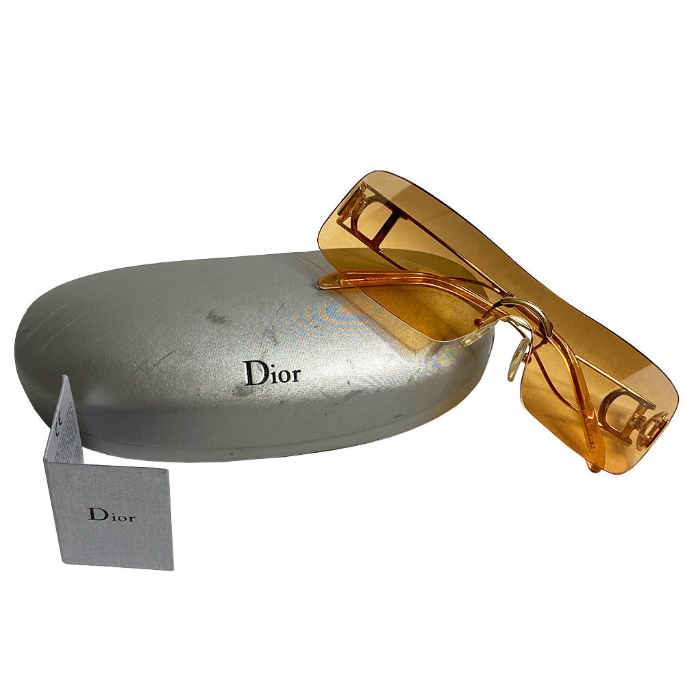 Christian Dior Miss Diorella sunglasses, rectangular slightly mirrored rimless shield lens with gold-tone metal split arms and logo D at temple, adjustable nose pieces 100% UV protection. Sunset orange with gold-tone metal frames Style: Missdiorella/N 34NSP 125 Case and card included. Made in Austria 