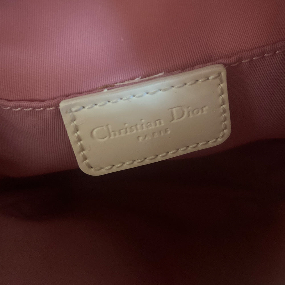 Christian Dior Girly pink monogram cross body reporter bag by John Galliano for Dior 2004 with pearl center white flowers, white piping, Swarovski crystal No 1 & Dior logo. Pink satin webbing adjustable shoulder strap with silver-tone Dior engraved sliders. Pink textile interior, one inner pocket. Made in Italy