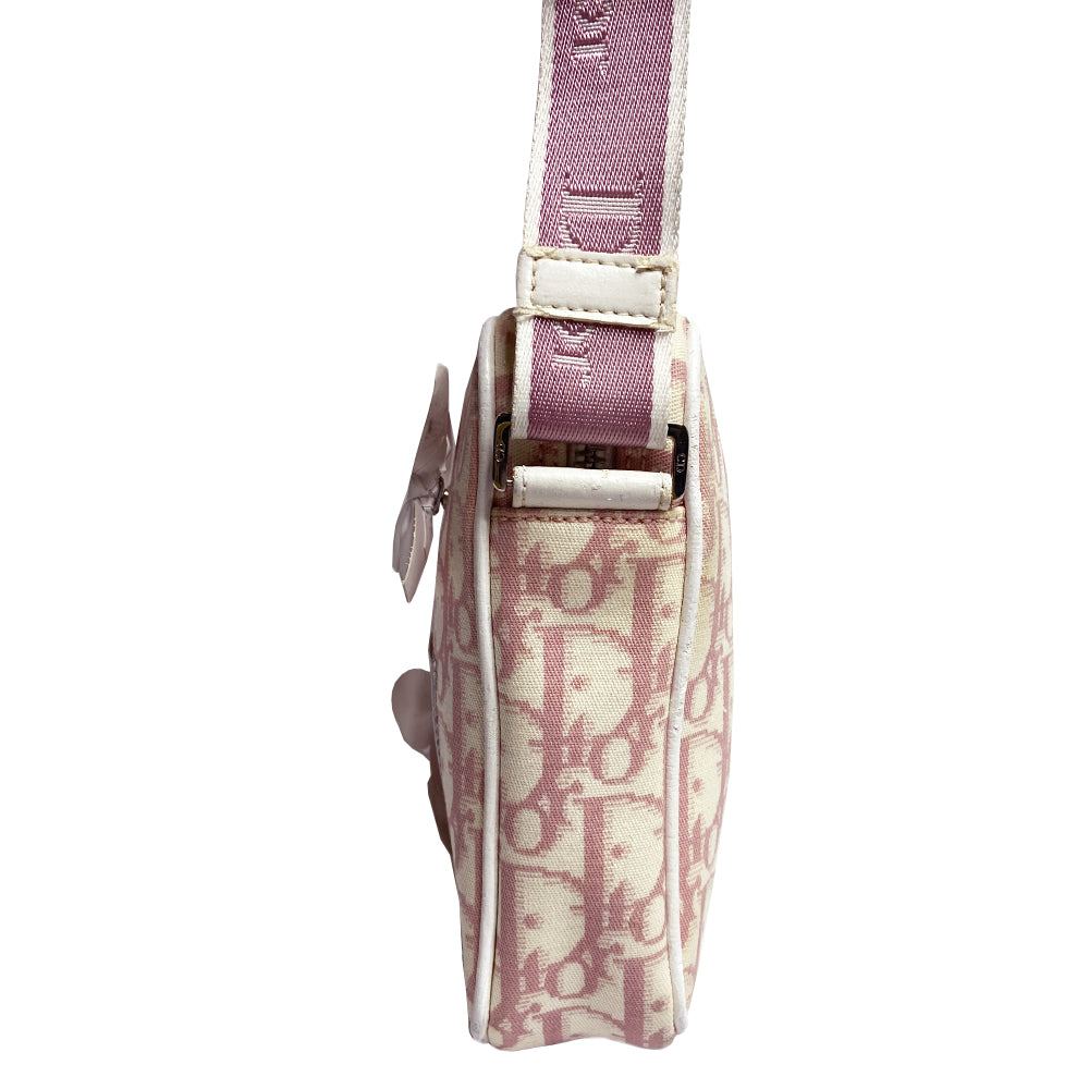 Christian Dior Girly pink monogram cross body reporter bag by John Galliano for Dior 2004 with pearl center white flowers, white piping, Swarovski crystal No 1 & Dior logo. Pink satin webbing adjustable shoulder strap with silver-tone Dior engraved sliders. Pink textile interior, one inner pocket. Made in Italy