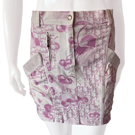 Christian Dior pink cherry blossom skirt by John Galliano for Dior circa 2004 from Logo Flowers Collection. Panelled skirt with belt loops, Dior logo elastic details. Front zipper closure with silver-tone logo button closure and embellished with front logo silver-tone zipper detail, 2 large side wrap around patch pockets. 
