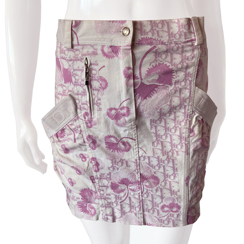 Christian Dior pink cherry blossom skirt by John Galliano for Dior circa 2004 from Logo Flowers Collection. Panelled skirt with belt loops, Dior logo elastic details. Front zipper closure with silver-tone logo button closure and embellished with front logo silver-tone zipper detail, 2 large side wrap around patch pockets. 