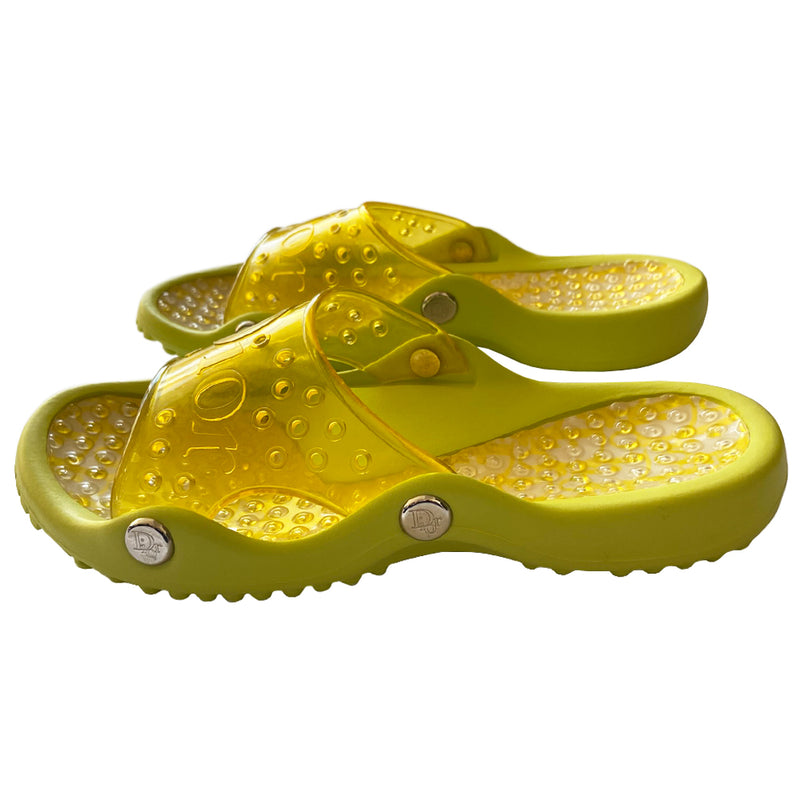 Christian Dior lime green and yellow monogram jelly pool slides, John Galliano era. Clear yellow upper with embossed Dior logo, perforated air holes, silver-tone Dior logo stud attachments at sides, monogram insole with clear nubby overlay for extra comfort. Rubber sole with grippy nubs and Dior logo imprint. Made in Italy 