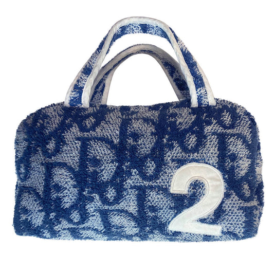 Christian Dior navy monogram terry towel mini boston bag circa 2005 with No. 2 white appliqué in front, white piping on handles and at zipper. Waterproof vinyl interior with 2 slip pockets, zipper closure with white textile ribbon zipper pull.