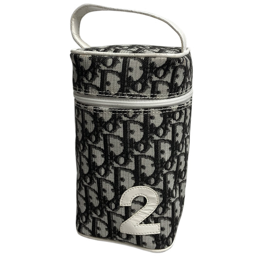 Christian Dior monogram mini vanity case by John Galliano for Dior, 2006. Black and grey monogram canvas rectangular cylinder with white patent piping, No 2 appliqué and top handle. Wrap around silver-tone top zipper closure, black textile interior. Made in Spain 