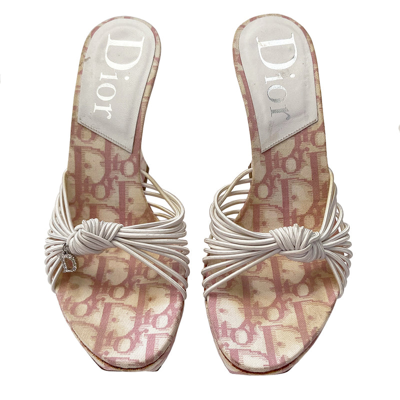Christian Dior pink monogram canvas Girly wedge slide sandals by John Galliano for Dior circa 2003.  1” platform with curved wedge heels and leather soles. Pink monogram insole with white leather Dior logo heel pad. Multiple white elastic cord strap upper gathered with top knot accent with crystal D logo charm. Made in Italy 