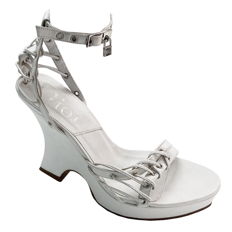 Christian Dior Street Chic rare ankle strap white leather wedge sandals from spring 2003 Dior ad campaign featuring Gisele Bündchen. White leather with small platform and wedge heels and leather soles. Silver grommet details with leather laces woven through Lock and key charms at ankle straps. Made in Italy