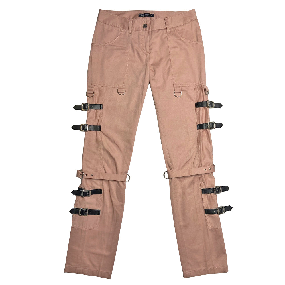 D&G pink Sex Bondage Strap Pants, SS 2003 SEX runway with 2 oversized front patch pockets, silver-tone hanging D rings. Side panels feature 4 black leather straps, logo engraved buckles, single adjustable fabric strap that wraps at knee. Cargo flap pocket in back with engraved silver-tone logo button, appliqué SEX logo patch. Made in Italy 