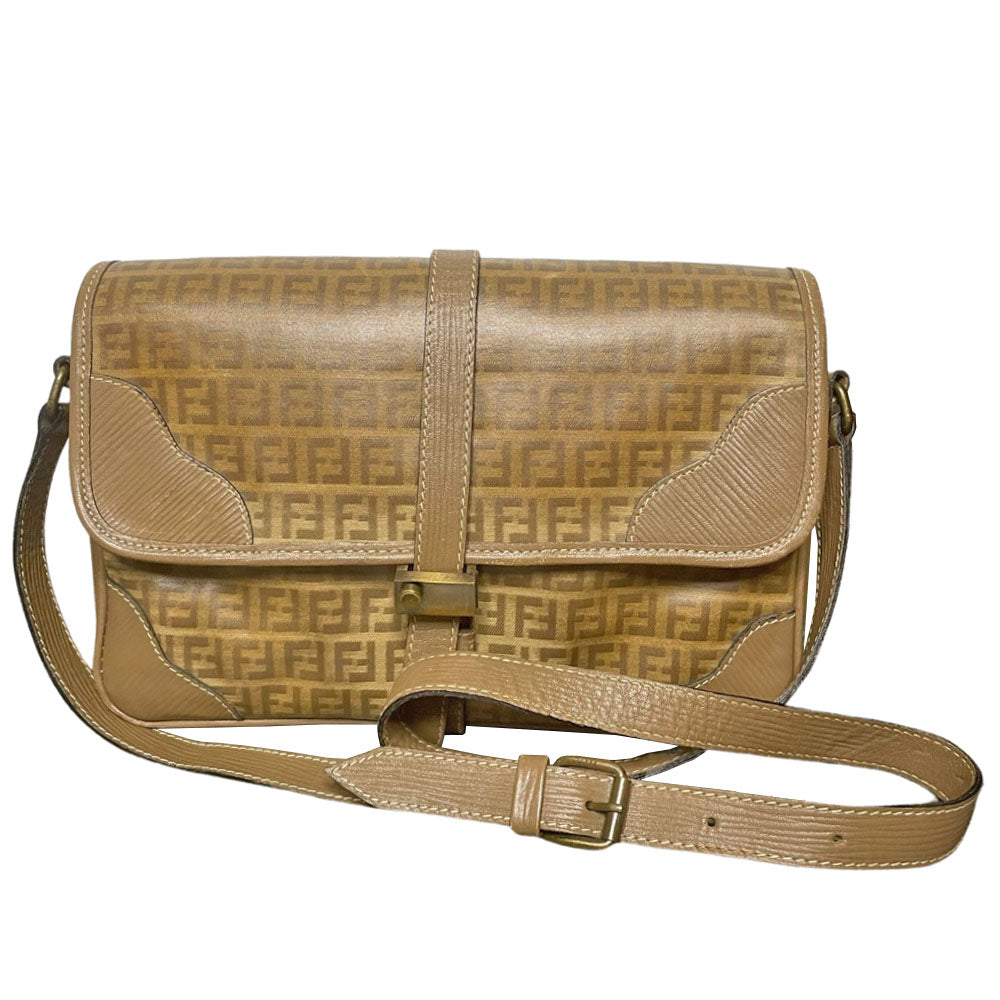 Fendi SAS circa 1970's tan and brown patent leather monogram FF Zucca print cross-body bag with front closure strap that wraps around bag and through brushed gold tone hardware. Long leather strap suitable to wear cross body, brown leather lining with three open interior sections and one zip pocket. Made in Italy 