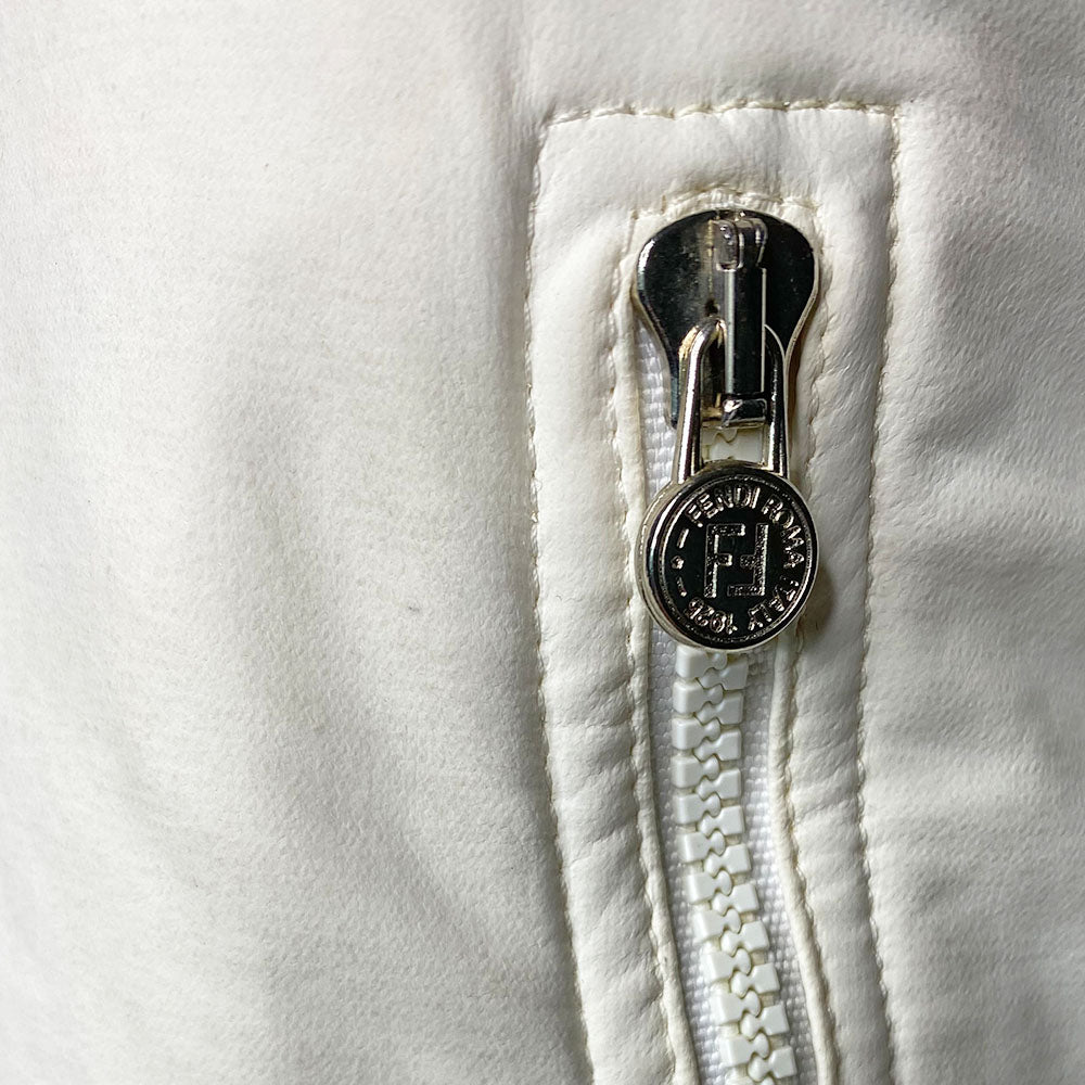 Fendi rubberized white with black piping exterior on terry cloth interior lining collared vest with silver-tone Fendi logo snap button front closure, black piping and Fendi Jeans logo ribbon detail at sides. 2 front zippered pockets with FF logo zipper pulls. Made in Italy