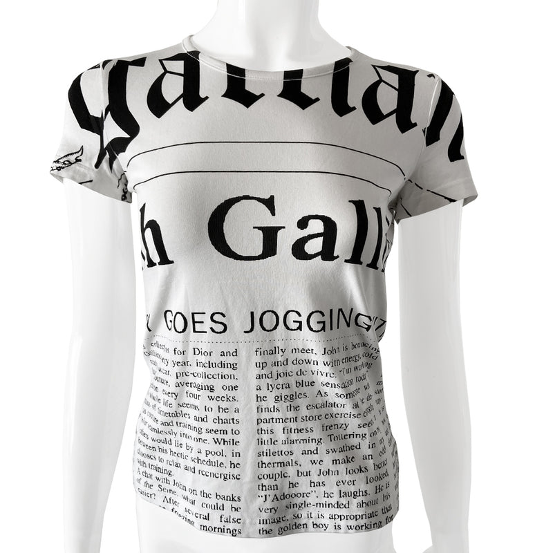 John Galliano Gazette Newsprint tee with signature Galliano gazette newsprint design in white with black print. Unisex style with short sleeves and rounded neckline. Size small in excellent condition, interior hologram authenticity tag attached.  Made in italy. 