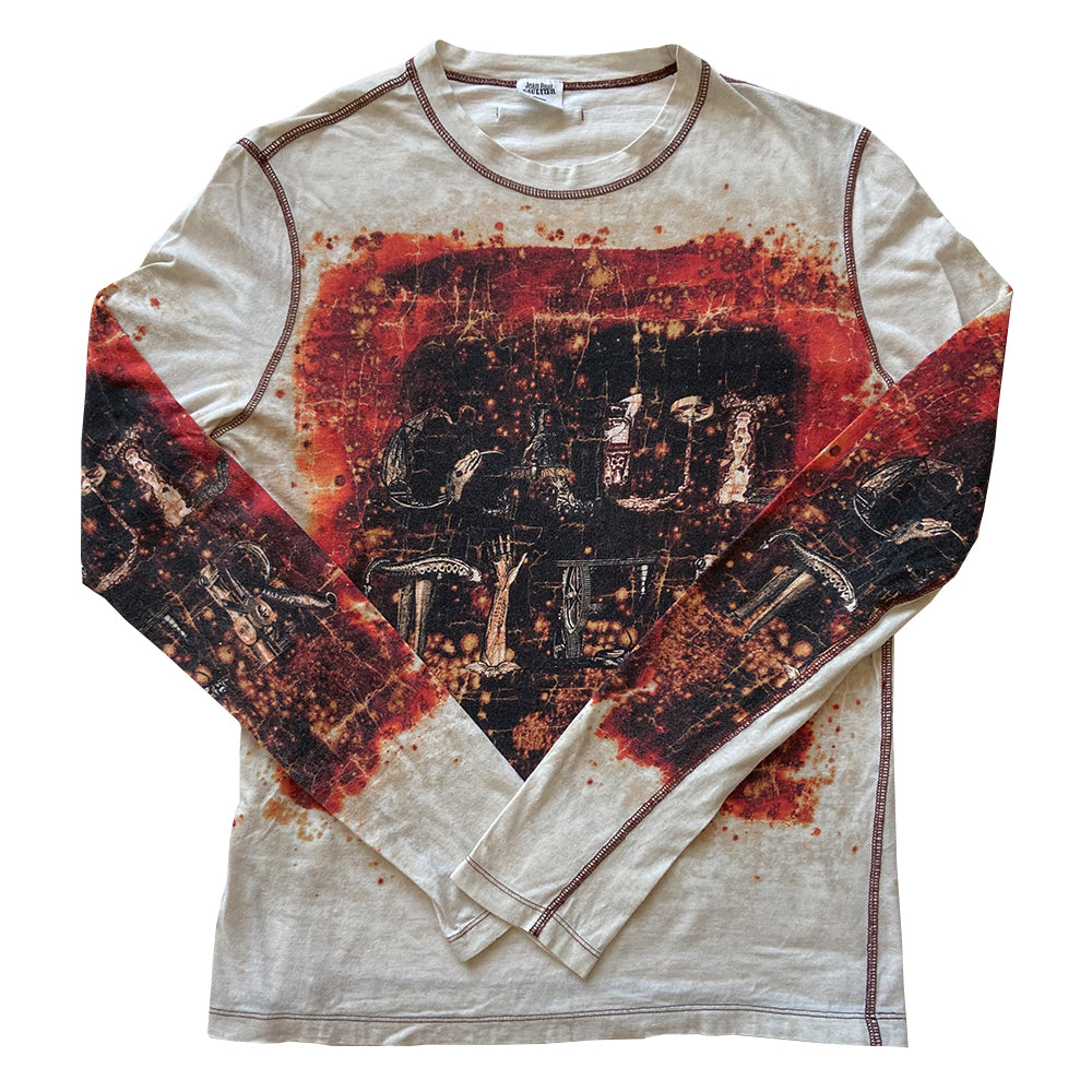 Jean Paul Gaultier Homme long sleeve tee circa 1990’s with crew neck and red contrast stitched seams. GAULTIER spelled out in depictions of snakes, lizards and arms on front, back and on sleeves with printed red splatter marks throughout. Tag size: M Main Color: White with red and black. Made in Japan 