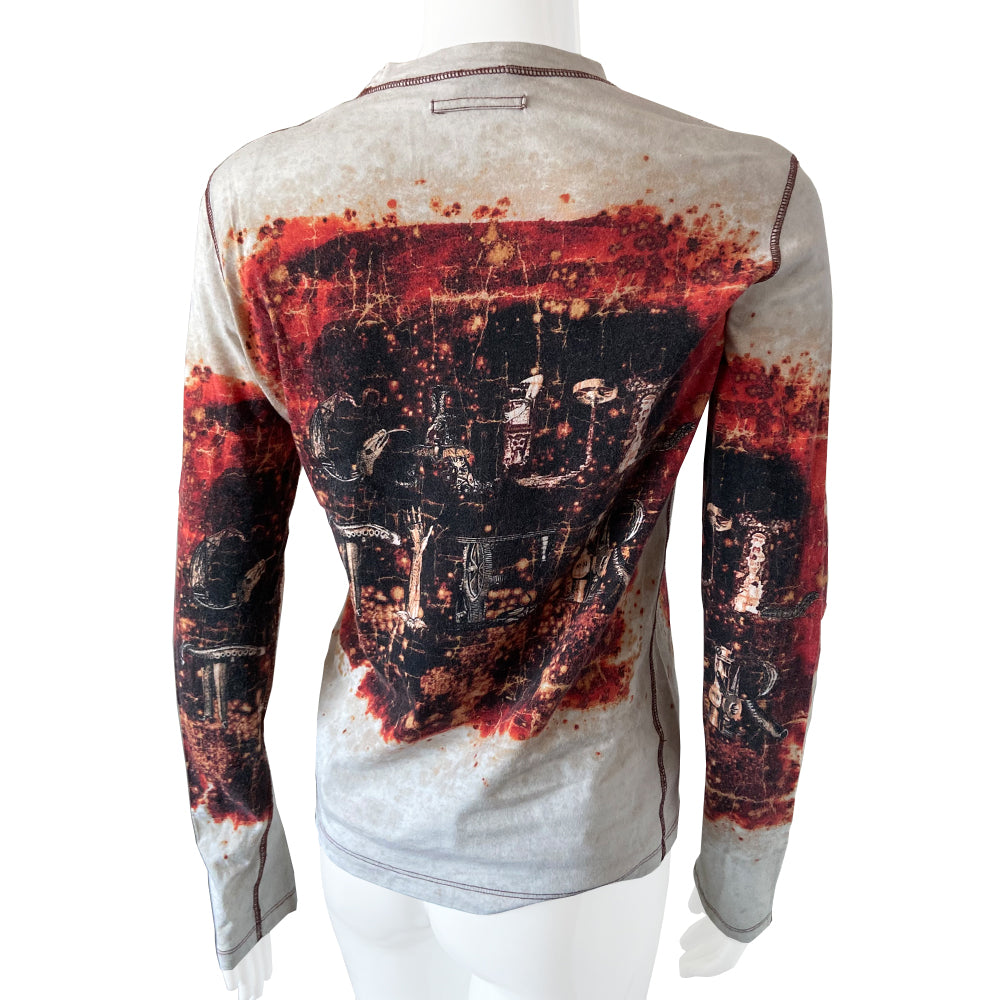 Jean Paul Gaultier Homme long sleeve tee circa 1990’s with crew neck and red contrast stitched seams. GAULTIER spelled out in depictions of snakes, lizards and arms on front, back and on sleeves with printed red splatter marks throughout. Tag size: M Main Color: White with red and black. Made in Japan 