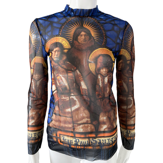 Jean Paul Gaultier stained glass saints mesh long sleeved top circa 1998 in blue, gold, tan. Front and back image a family of Saints on a background of stained glass with Jean Paul Gaultier printed along hemline and on sleeves. Tag size: 40. Made in Japan