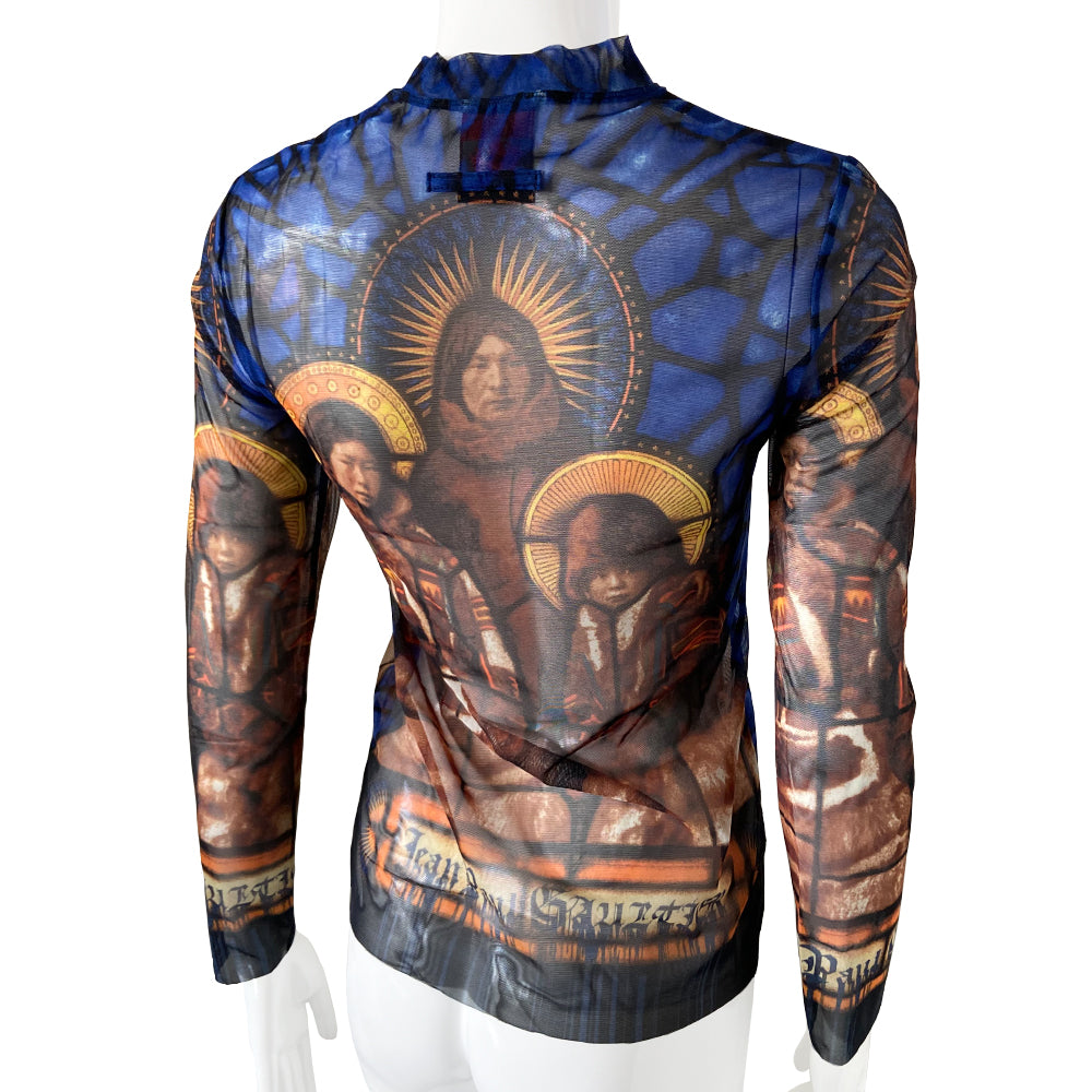 Jean Paul Gaultier stained glass saints mesh long sleeved top circa 1998 in blue, gold, tan. Front and back image a family of Saints on a background of stained glass with Jean Paul Gaultier printed along hemline and on sleeves. Tag size: 40. Made in Japan