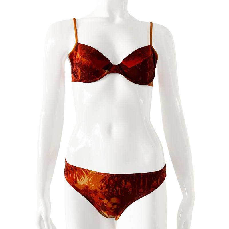 New Jean Paul Gaultier orange/black/gold color Hawaiian graphic print bikini from the Soleil collection. Top and mid-rise bottoms feature Hawaiian girl against tropical background. Soft unstructured bra with underwire cups, back clasp closure, contrast stretch straps. Partially lined Size: IT 42 Made in Italy