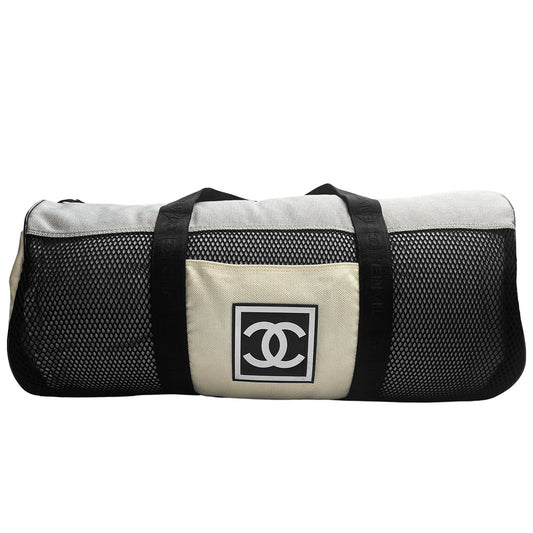 Chanel sport canvas and mesh large grey/black/cream duffle bag by Karl Lagerfeld for Chanel, 2003/2004 zipper closure and boxed rubber CC front logo, 2 exterior end pockets and one exterior front pocket. Double Chanel embossed satin webbing logo carry straps. Serial number sticker attached. Made in Italy
