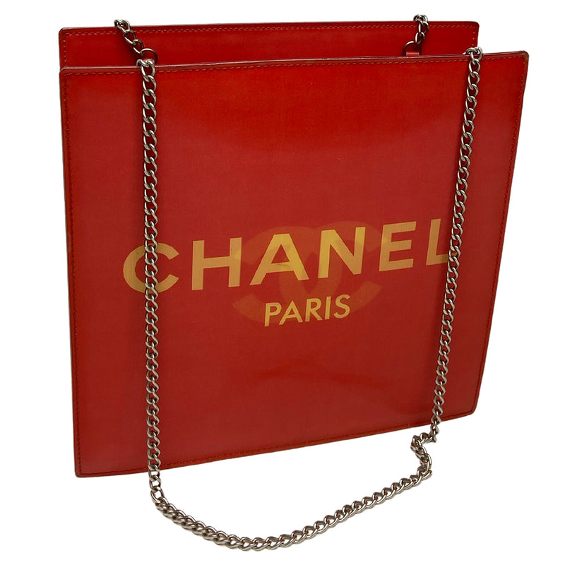 Chanel rectangular vinyl shoulder bag by Karl Lagerfeld for Chanel 2000 with silver-tone double chain shoulder strap and lenticular/holograph design that flip flops between gold-tone interlocking CC logo and CHANEL Paris. Open top, vinyl interior and one zippered pocket with silver-tone Chanel engraved zipper pull. Made in France 