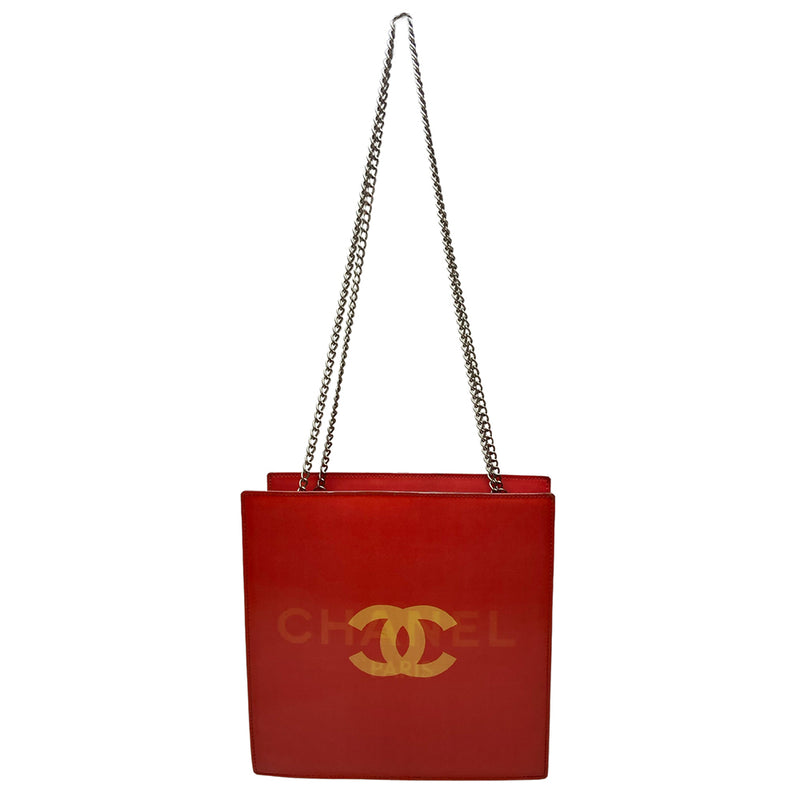 Chanel rectangular vinyl shoulder bag by Karl Lagerfeld for Chanel 2000 with silver-tone double chain shoulder strap and lenticular/holograph design that flip flops between gold-tone interlocking CC logo and CHANEL Paris. Open top, vinyl interior and one zippered pocket with silver-tone Chanel engraved zipper pull. Made in France 