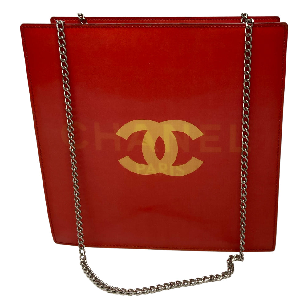 Chanel rectangular vinyl shoulder bag by Karl Lagerfeld for Chanel 2000 with silver-tone double chain shoulder strap and lenticular/holograph design that flip flops between gold-tone interlocking CC logo and CHANEL Paris. Open top, vinyl interior and one zippered pocket with silver-tone Chanel engraved zipper pull. Made in France 