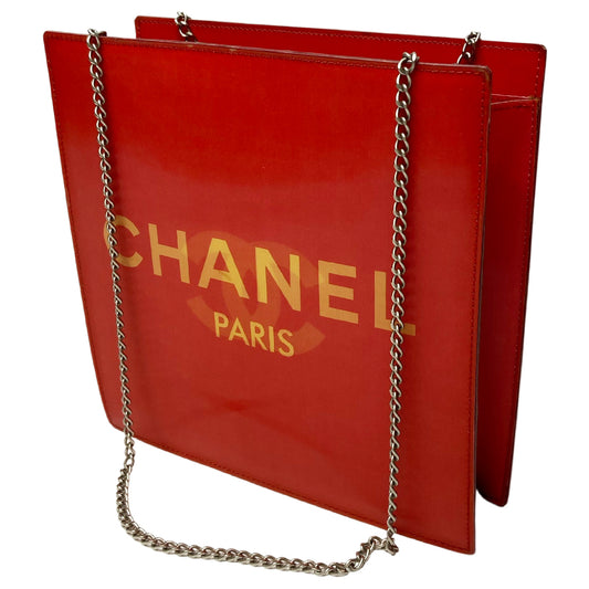 Chanel rectangular vinyl shoulder bag by Karl Lagerfeld for Chanel 2000 with silver-tone double chain shoulder strap and lenticular/holograph design that flip flops between gold-tone interlocking CC logo and CHANEL Paris. Open top, vinyl interior and one zippered pocket with silver-tone Chanel engraved zipper pull. Made in France 
