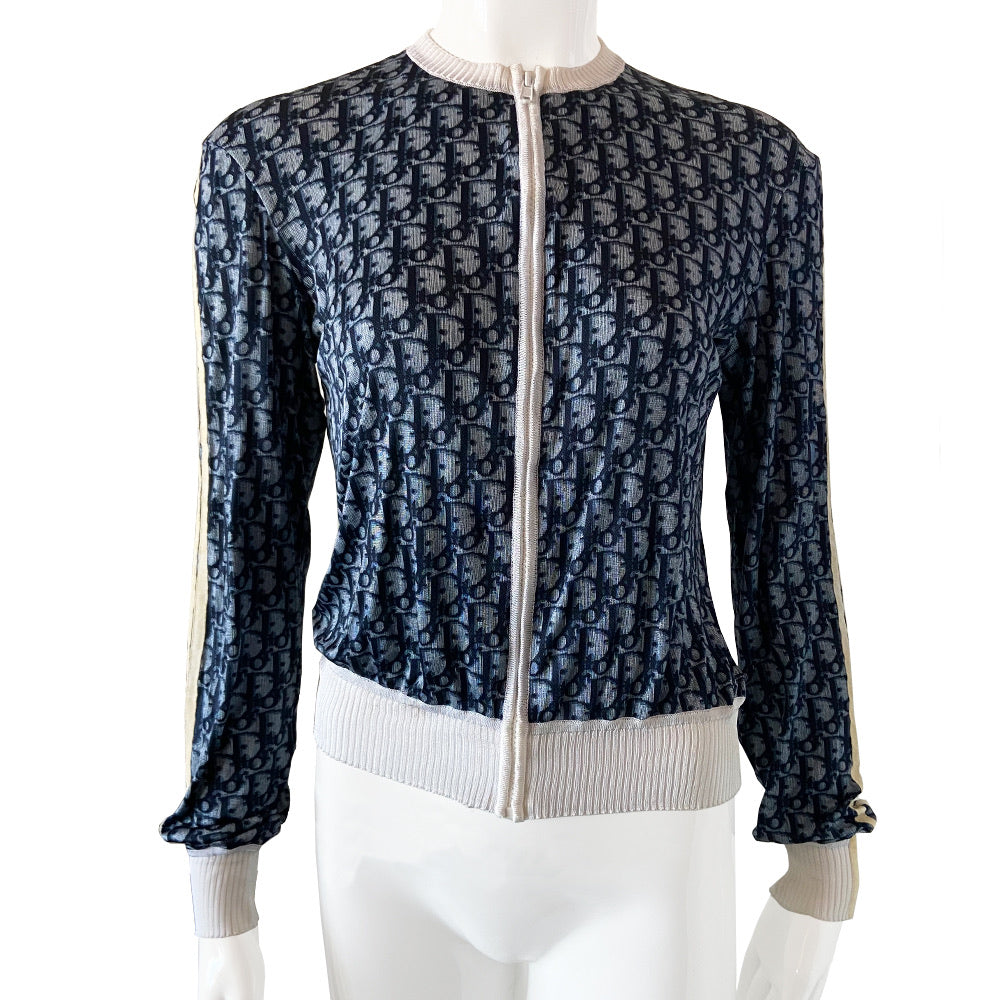 Christian Dior navy monogram on white zip jacket From 2002 by John Galliano for Dior. Long sleeved front zip Diorissimo print long sleeved with white accent ribbing at neckline and cuffs, 2 off-white stripes on each sleeve. Fabric: 100% Viscose Tag Size: FR 42. Made in France 