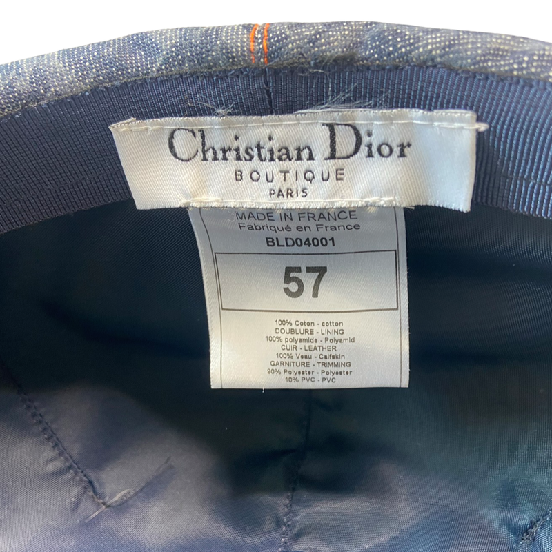 Christian Dior navy monogram flat cap by John Galliano for Dior, 2004 with orange contrast stitching, orange band, calf leather accent trim and orange rubber Dior logo hanging tag attached. Grosgrain interior ribbon and navy textile lining. Made in France