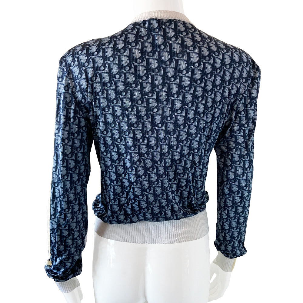 Christian Dior navy monogram on white zip jacket From 2002 by John Galliano for Dior. Long sleeved front zip Diorissimo print long sleeved with white accent ribbing at neckline and cuffs, 2 off-white stripes on each sleeve. Fabric: 100% Viscose Tag Size: FR 42. Made in France 