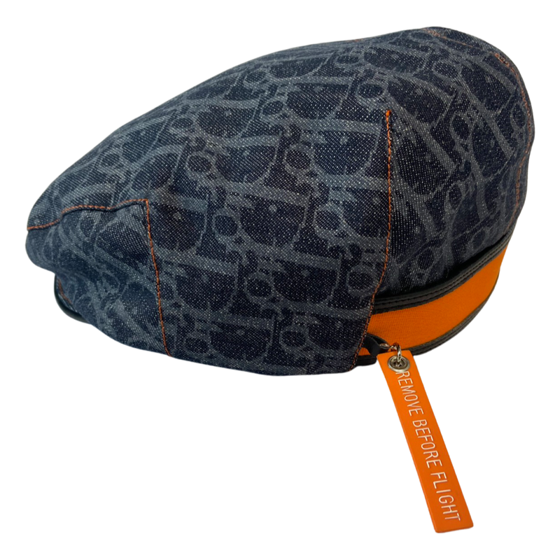 Christian Dior navy monogram flat cap by John Galliano for Dior, 2004 with orange contrast stitching, orange band, navy calf leather accent trim and orange rubber Dior logo hanging tag attached. Grosgrain interior ribbon and navy textile lining. Made in France