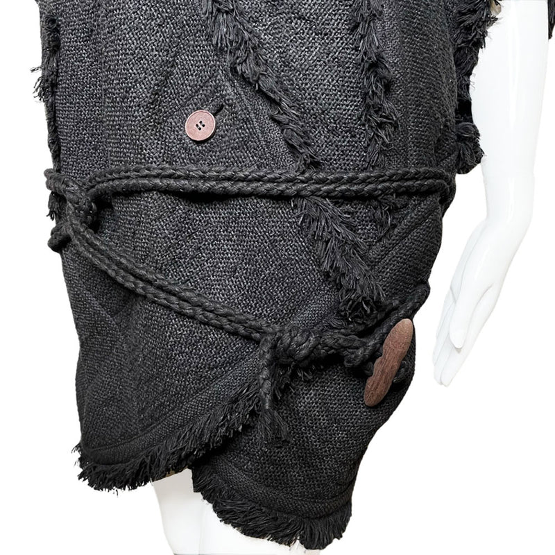  Fall 1984 Issey Miyake black fringed woven vest documented in Irving Penn's book, "Issey Miyake Photographs By Irving Penn", page 32 with back ornament detail featuring beads, sequins and embroidery with two side pockets, rope belt toggle tie, single front button. Style: NO ED67194. Made in Japan