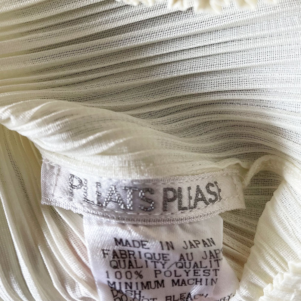 Issey Miyake Pleats Please off white long sleeve finely pleated mock neck top, circa 1990's with rounded shoulders. Made in Japan