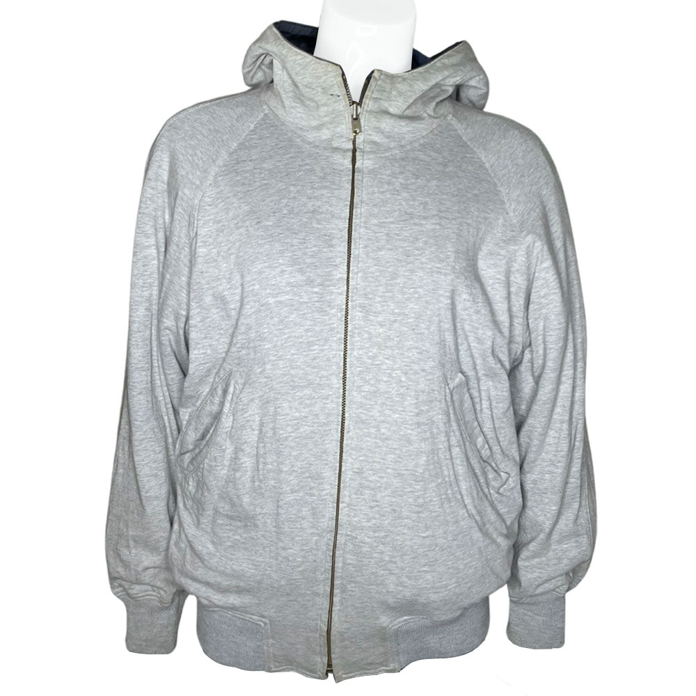 Issey Miyake by Tsumori Chisato navy zip hooded jacket with 2 front angled button flap pockets, ribbed cuffs and bottom hem, I.S. printed on back. Reversible with Interior lined in light grey jersey with two inner slip pockets. Made in Japan