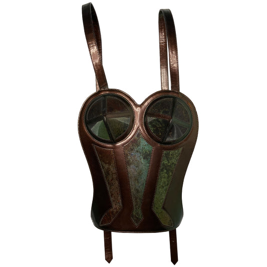 Jean Paul Gaultier 1998 leather backpack in the shape of the Gaultier iconic corset embellished with hologram vinyl front inserts, antique brass hardware. Adjustable length leather straps, Jean Paul Gaultier embossed in back, top dual Gaultier engraved zippers, textile lining, interior zip pocket.  