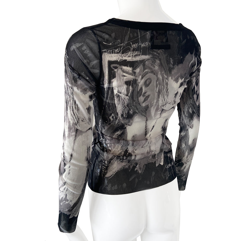 Jean Paul Gautier posing woman black and white long sleeve mesh top by Jean Paul Gaultier, JPG circa mid 90’s with posing woman graphic and Jean Paul Gaultier signature on front, back and sleeves Black banded scoop neck. Tage size: 40 Made in Japan