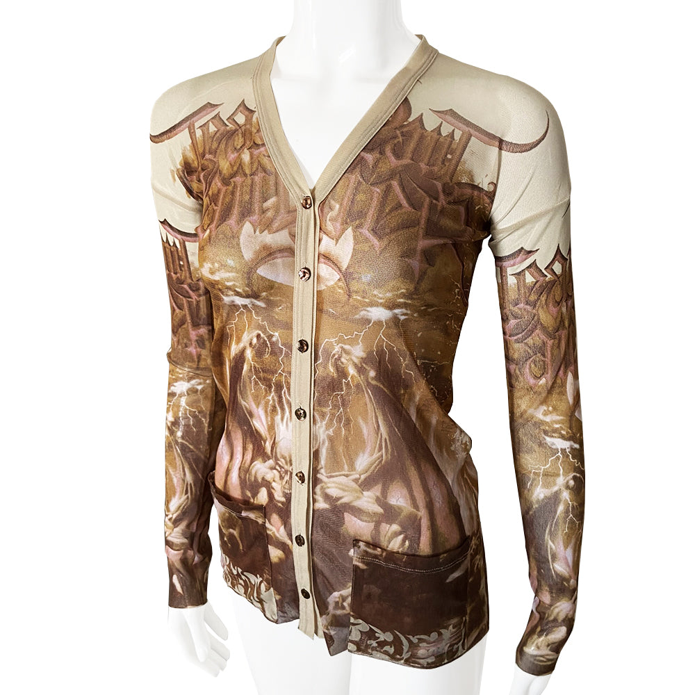Jean Paul Demon rare beige and light brown cardigan from John Paul Gaultier Femme, 2001 in stretch mesh featuring winged demon on front and back and Jean Paul Gaultier name in gothic print with gold-tone button front closure, 2 patch style front pockets. 100% Polyamide Size: 40 Made in Japan 
