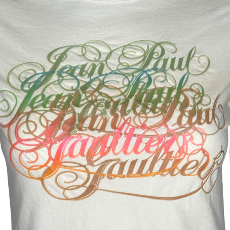Jean Paul Gaultier Femme label raw edge neck short sleeved white tee with multiple overlapping mint, aqua, brown, beige, pink painted cursive logos at front.