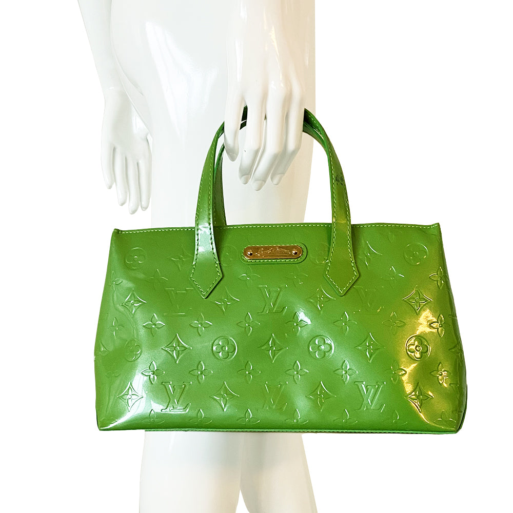 Louis Vuitton Wilshire PM Circa 1998-2000s with marks on the exterior and interior trim glazing. Gold-tone hardware and exterior engraved name plate with matching textile interior and one zip pocket. Single D-ring lobster claw style interior closure Color: Vert Tonic Made in France 