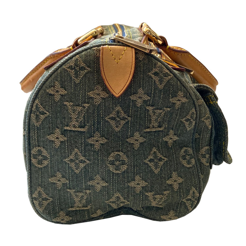Louis Vuitton blue stonewashed monogram denim Neo Speedy Bag by Marc Jacobs for Louis Vuitton, 2005. 2 outer front pockets with gold-tone push lock closures and outer zip pocket. Vachetta leather trimmed with 2 rolled leather handles. Top zipper closure opens to gold/tan alcantara lining, one interior slip pocket. Made in France