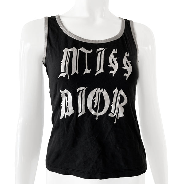 Christian Dior rare Gothic Script Tank circa 2002 by John Galliano for Dior Super soft stretch fabric with piping at neckline and arm holes.  Color: Black with white script lettering and accent.  Fabric: 95% Cotton, 5% Lycra Made in Italy Missing size tag Nape of Neck to Bottom Hem (in) 18.5" Chest approx (in) 16"