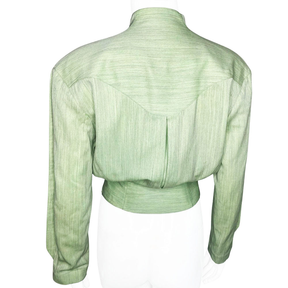 Thierry Mugler 1980's seafoam green wool jacket with angled front flap featuring the iconic Mugler wave, green acetate belt and triangle buttons. Three front snap closures, two at waist and one at chest, back pleats and blouson body. Made in France 