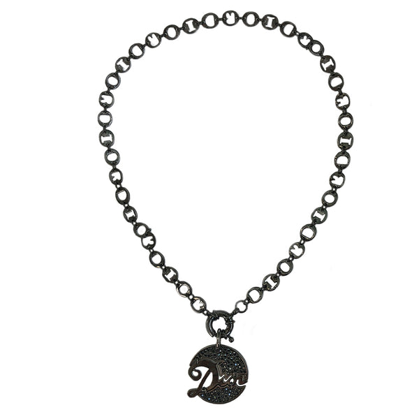 Christian Dior graphite-tone charm necklace. 9.25” chain links spell DIOR. Graphite tone crystals surround Dior signature pendant with front toggle clasp. 