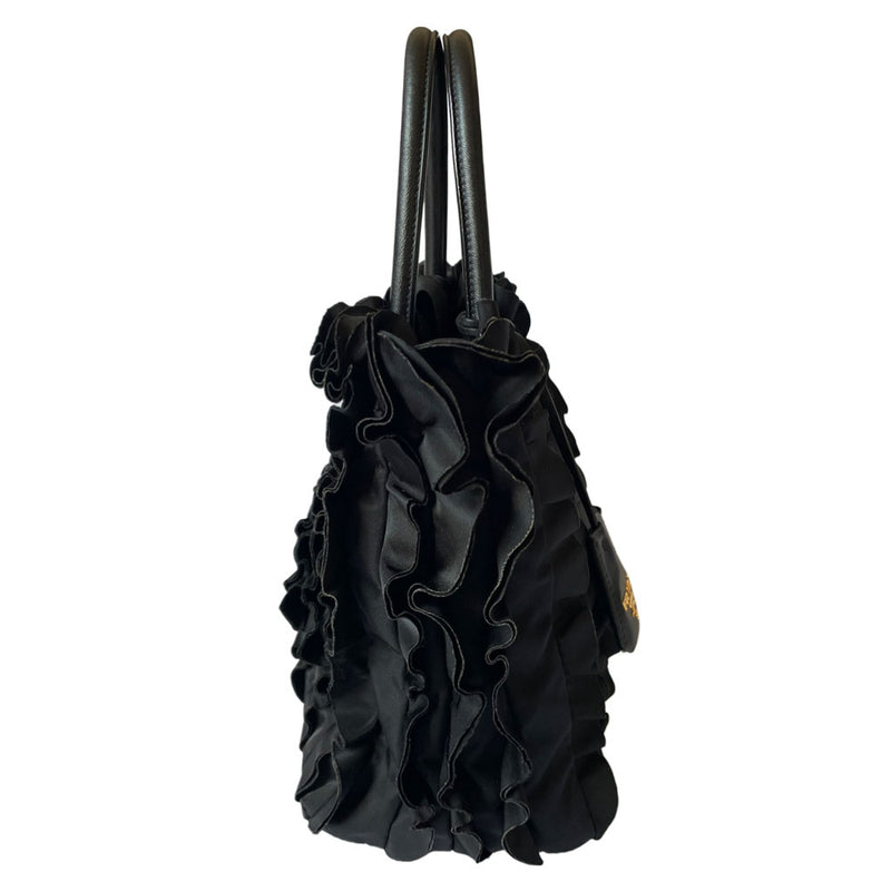 Prada 2000s black ruffled body tessuto nylon tote with leather handles, accent and hanging clochette key holder featuring gold-tone logo. Gold-tone hardware, interior logo, zippers and logo engraved feet. Magnetic snap closure, interior trademark leather label, 2 interior zip pockets, Prada logo lining. Made in Italy 