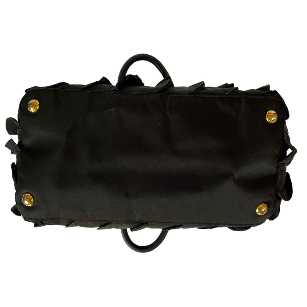 Prada 2000s black ruffled body tessuto nylon tote with leather handles, accent and hanging clochette key holder featuring gold-tone logo. Gold-tone hardware, interior logo, zippers and logo engraved feet. Magnetic snap closure, interior trademark leather label, 2 interior zip pockets, Prada logo lining. Made in Italy 