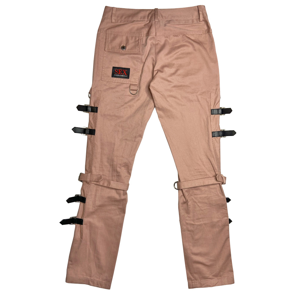 D&G pink Sex Bondage Strap Pants, SS 2003 SEX runway with 2 oversized front patch pockets, silver-tone hanging D rings. Side panels feature 4 black leather straps, logo engraved buckles, single adjustable fabric strap that wraps at knee. Cargo flap pocket in back with engraved silver-tone logo button, appliqué SEX logo patch. Made in Italy 