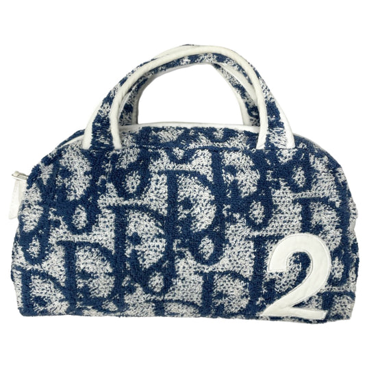 Christian Dior navy monogram terry towel mini boston bag circa 2005 with No. 2 white appliqué in front, white piping on handles and zipper. Waterproof vinyl interior with 2 slip pockets Zipper closure with white textile ribbon zipper pull. 